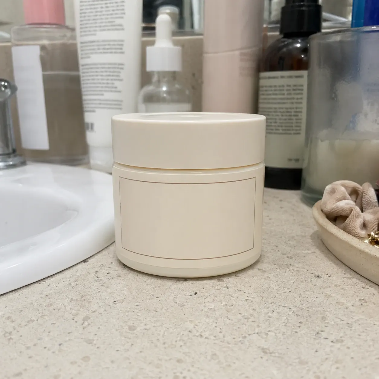 Before image of a skincare jar on a cluttered bathroom counter before ChatGPT background replacement.